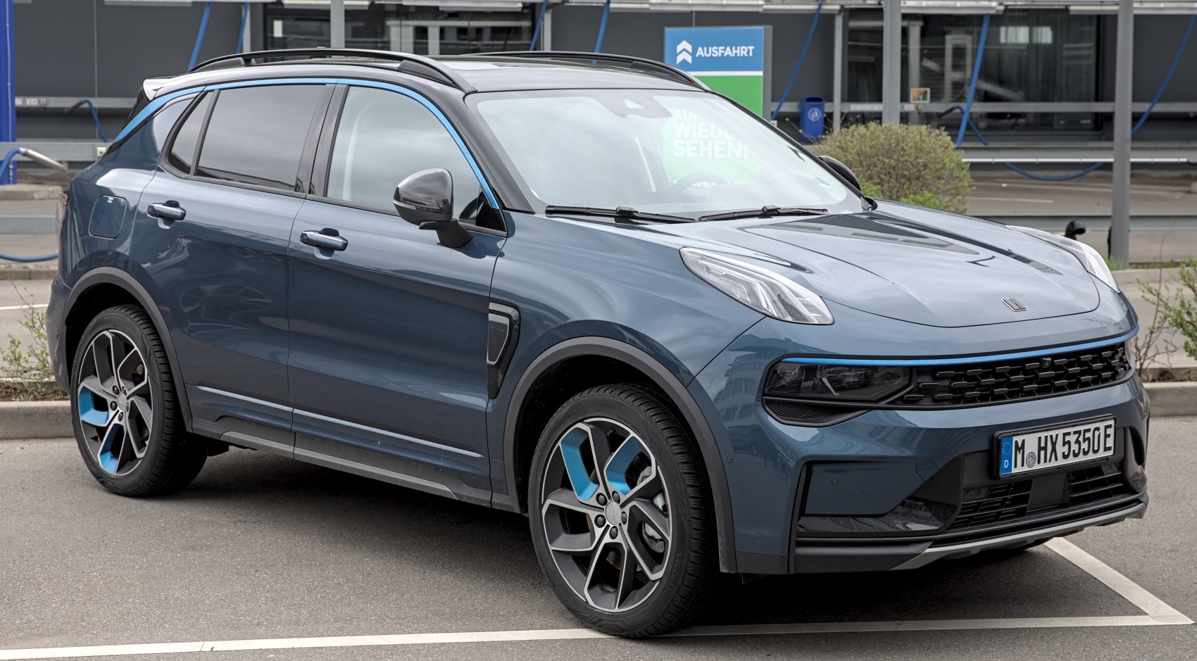 Front and side view with distinctive headlight and alloy wheel design.