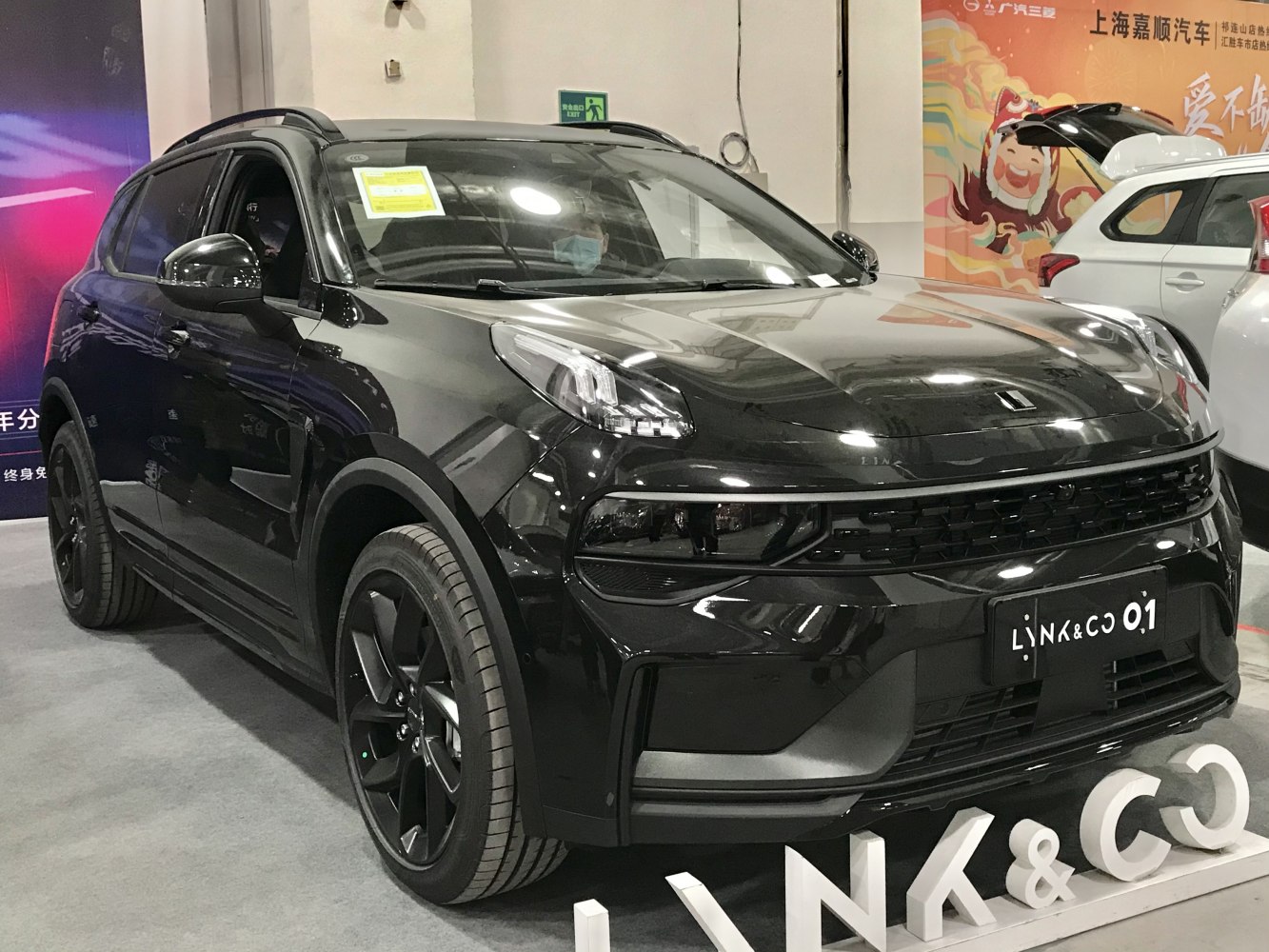 Front angle view of a black SUV with LED headlights and sporty alloy wheels.