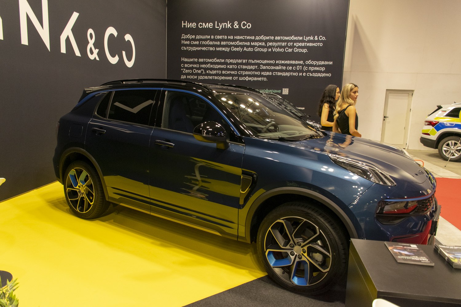 Modern SUV side view with unique blue-accented alloy wheels.
