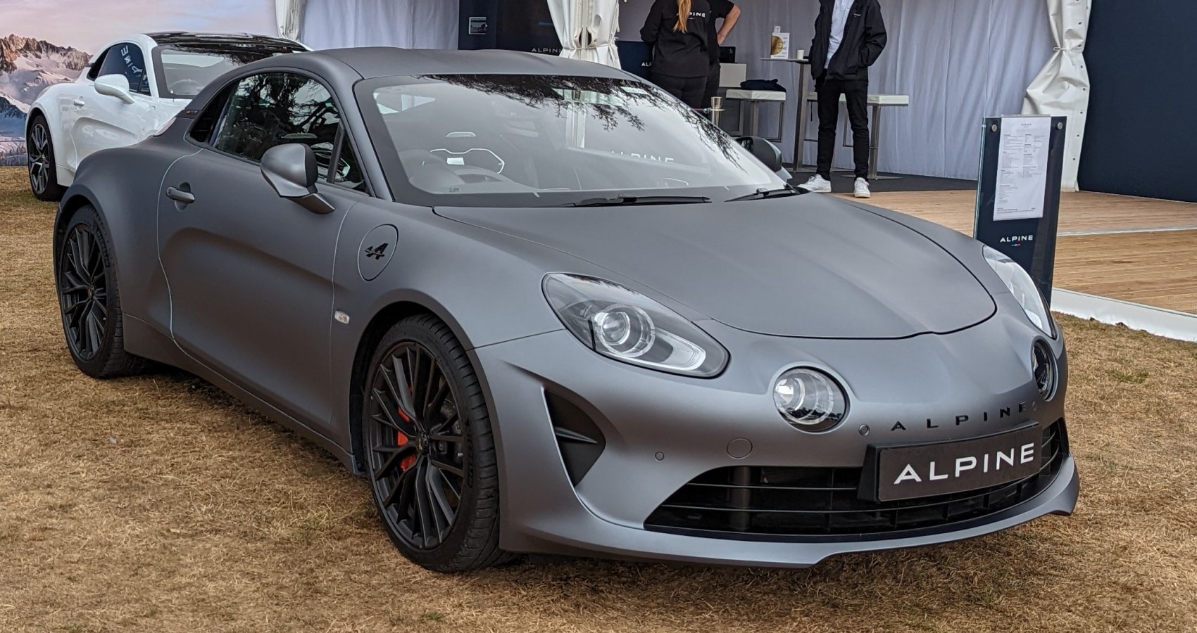 Matte gray two-door coupe with quad front headlights and sporty black wheels.