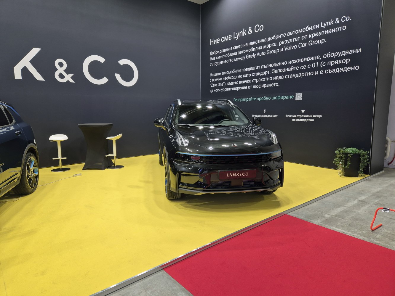Sleek black SUV front view with LED headlights displayed indoors