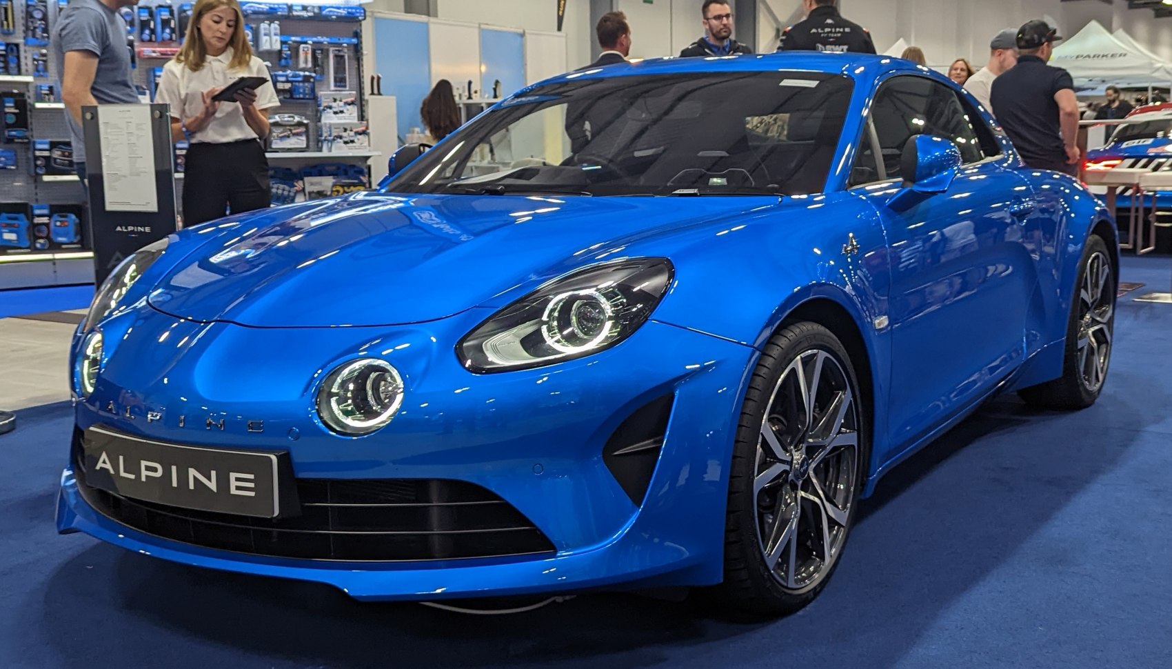 Vibrant blue sports coupe with distinctive LED circular headlights and multi-spoke alloy wheels.