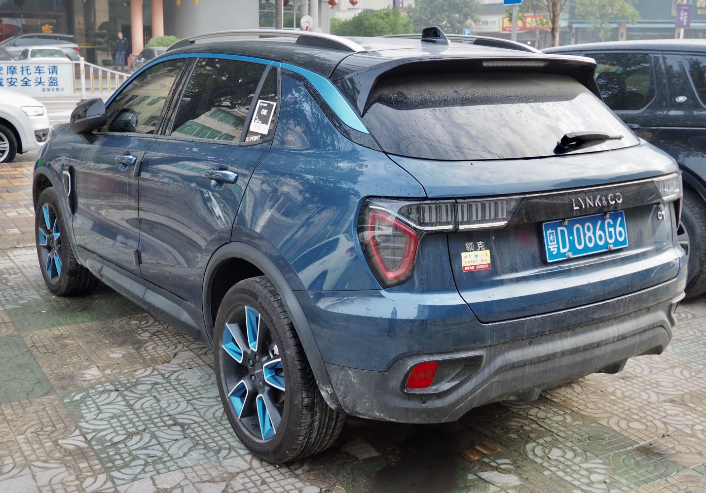 SUV rear view with blue-accented alloy wheels and modern tail lights