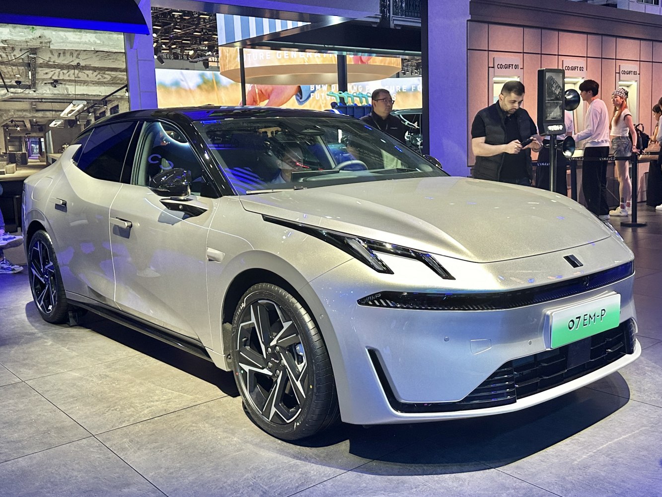 Modern LED headlights and aerodynamic body design of an EV at auto show