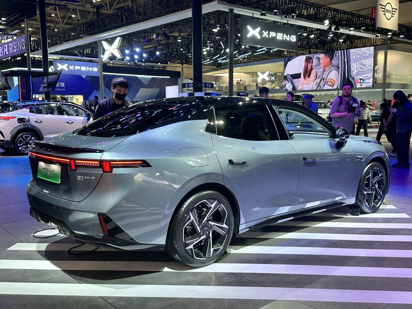 Sleek electric sedan with angular tail lights and aerodynamic smooth body design.