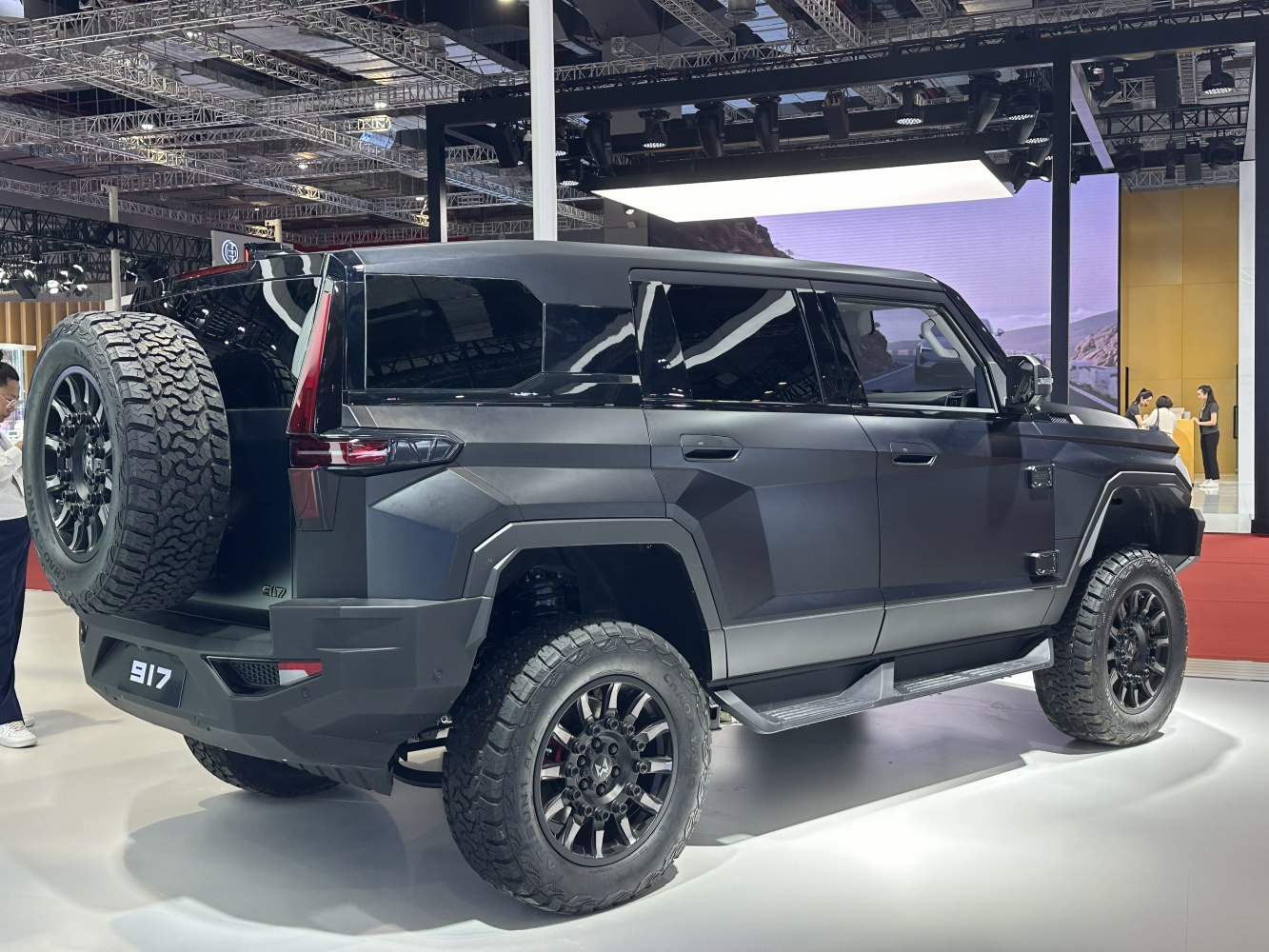 Angular SUV with rugged design, off-road tires, and rear spare wheel
