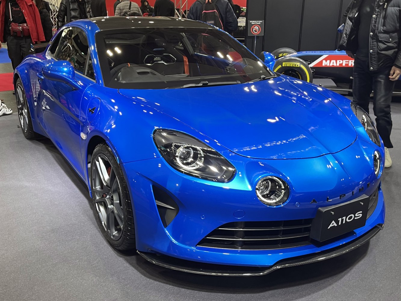Blue sports coupe with rounded headlights and aerodynamic front
