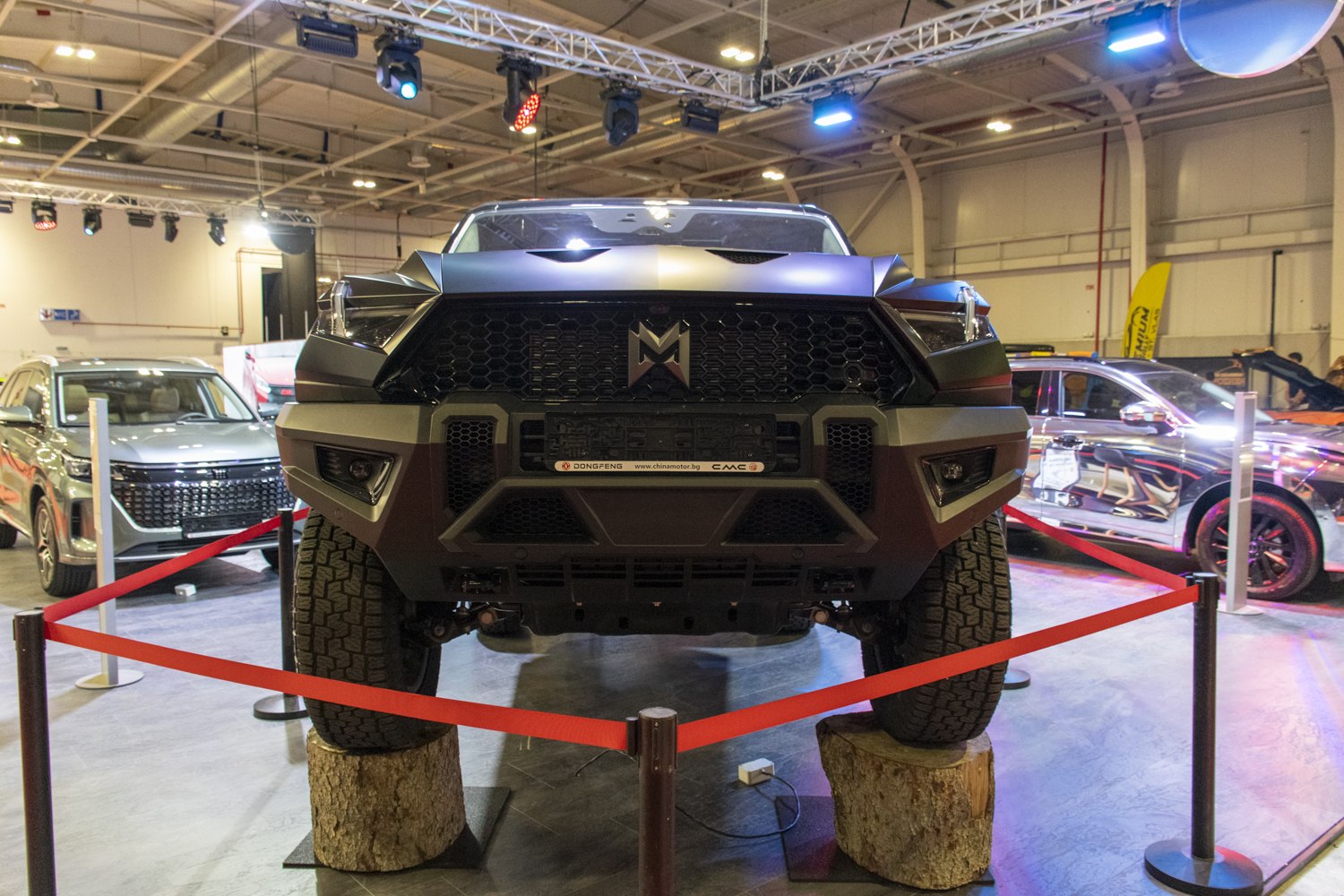 Close-up of front grill and off-road suspension with rugged tires