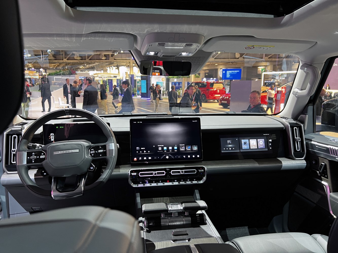 Car interior with dual digital screens and advanced steering wheel controls
