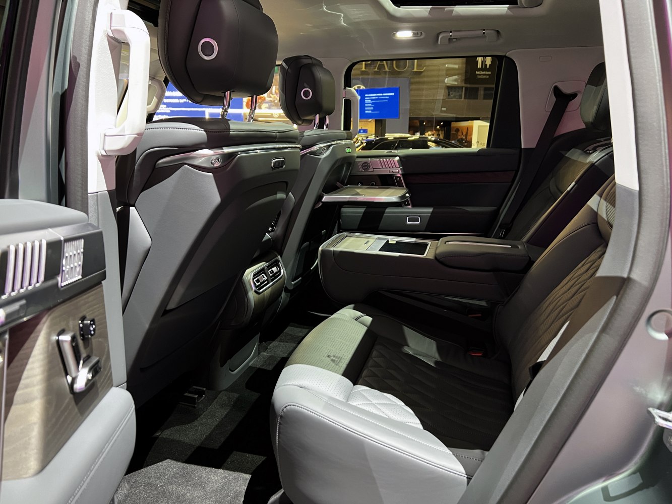 Luxury rear passenger seating with foldable tray and advanced comfort features