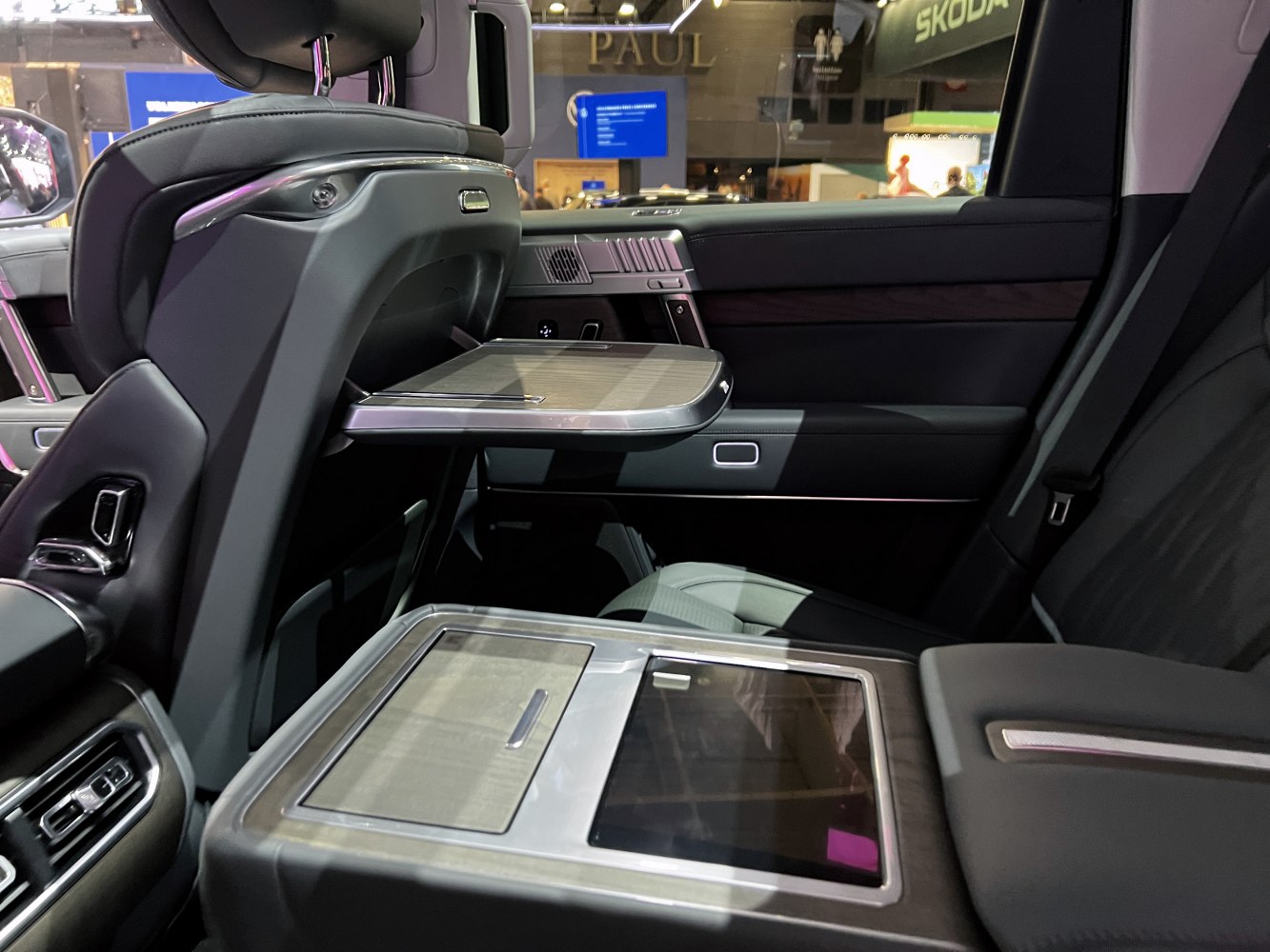 Rear seat folding tray with center console in premium vehicle interior