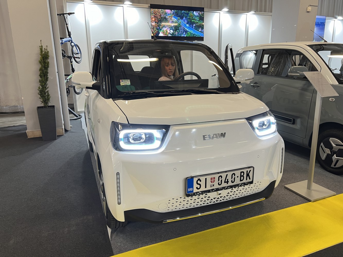 Compact electric car with LED headlights and sleek front design
