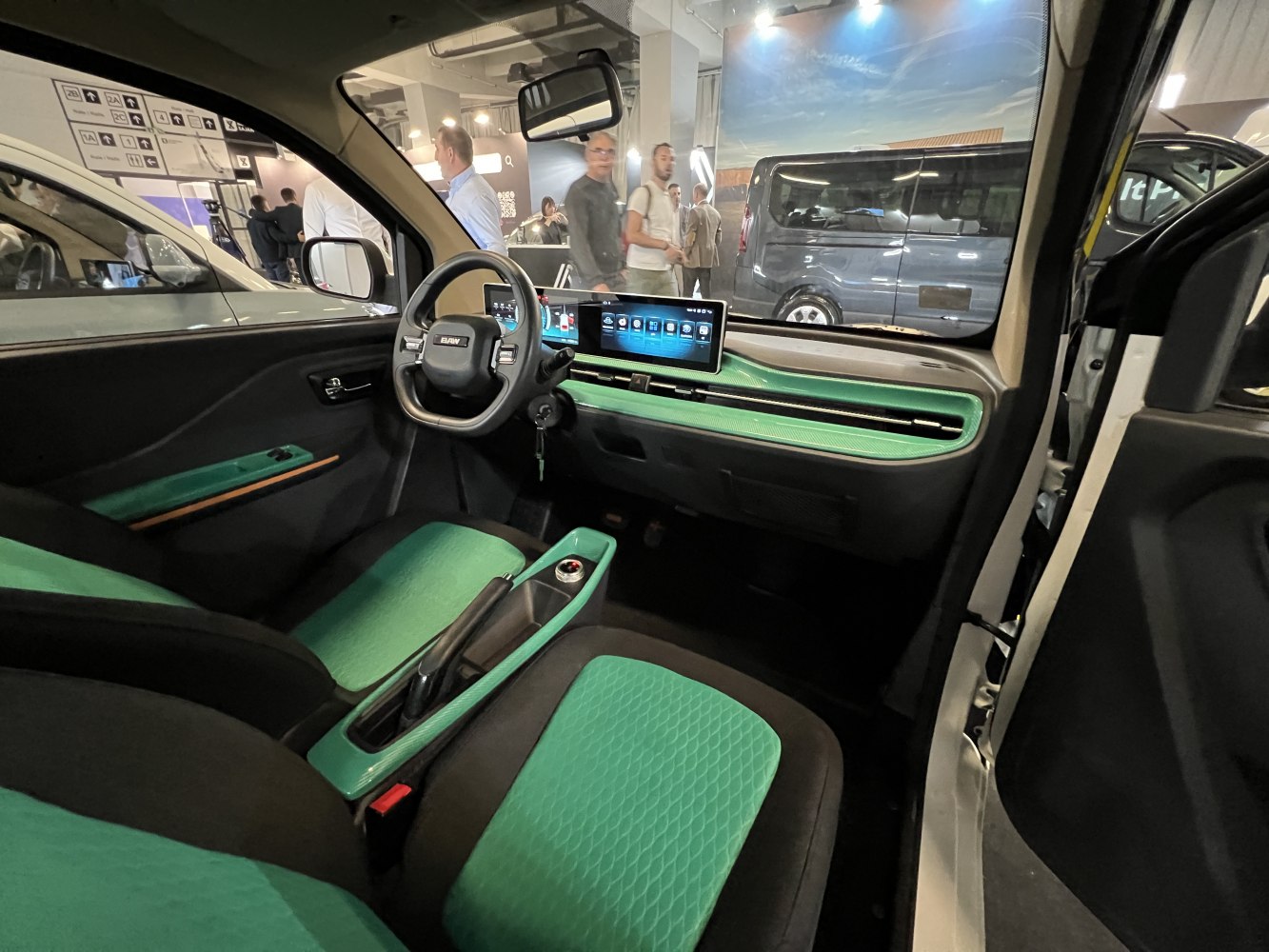 Digital dashboard and green seat upholstery in car interior