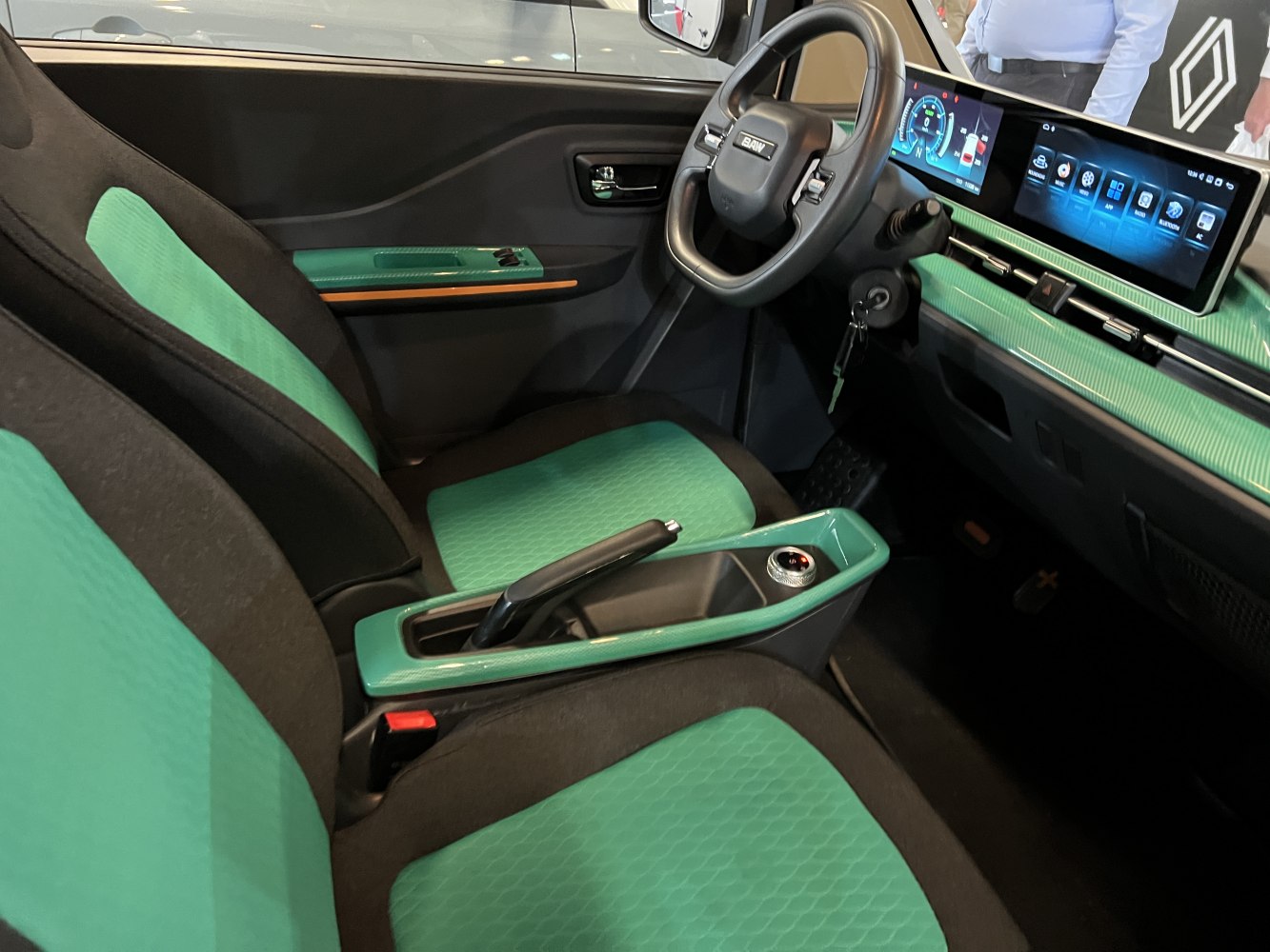 Green upholstery and digital dashboard displays with modern steering wheel