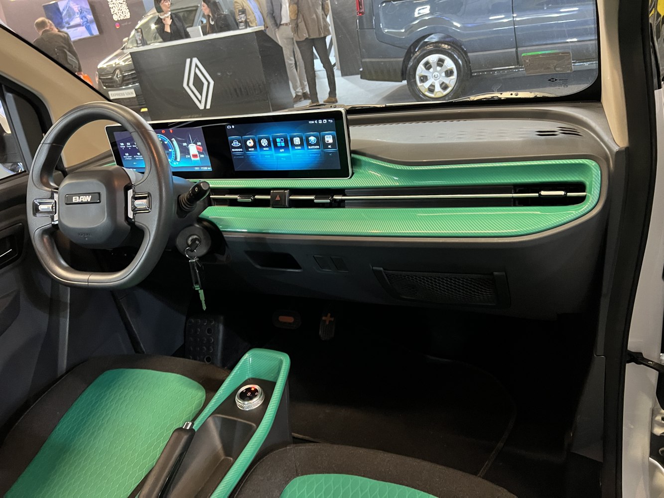 Digital dashboard and touchscreen interface with green accent trims in a modern car interior