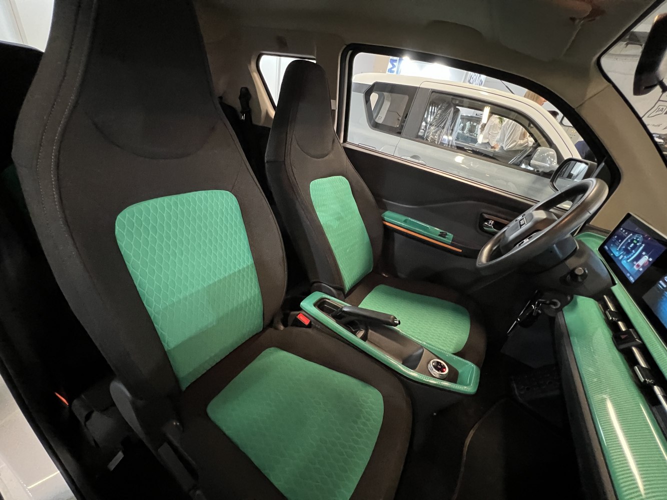 Modern car interior with green trimmed seats and dashboard accents