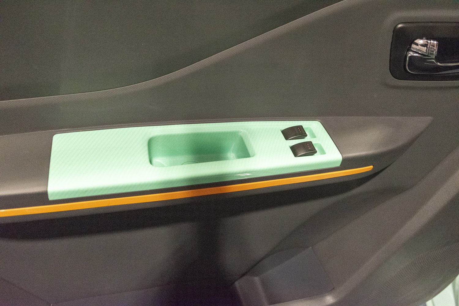 Interior car door panel with power window switches and chrome handle