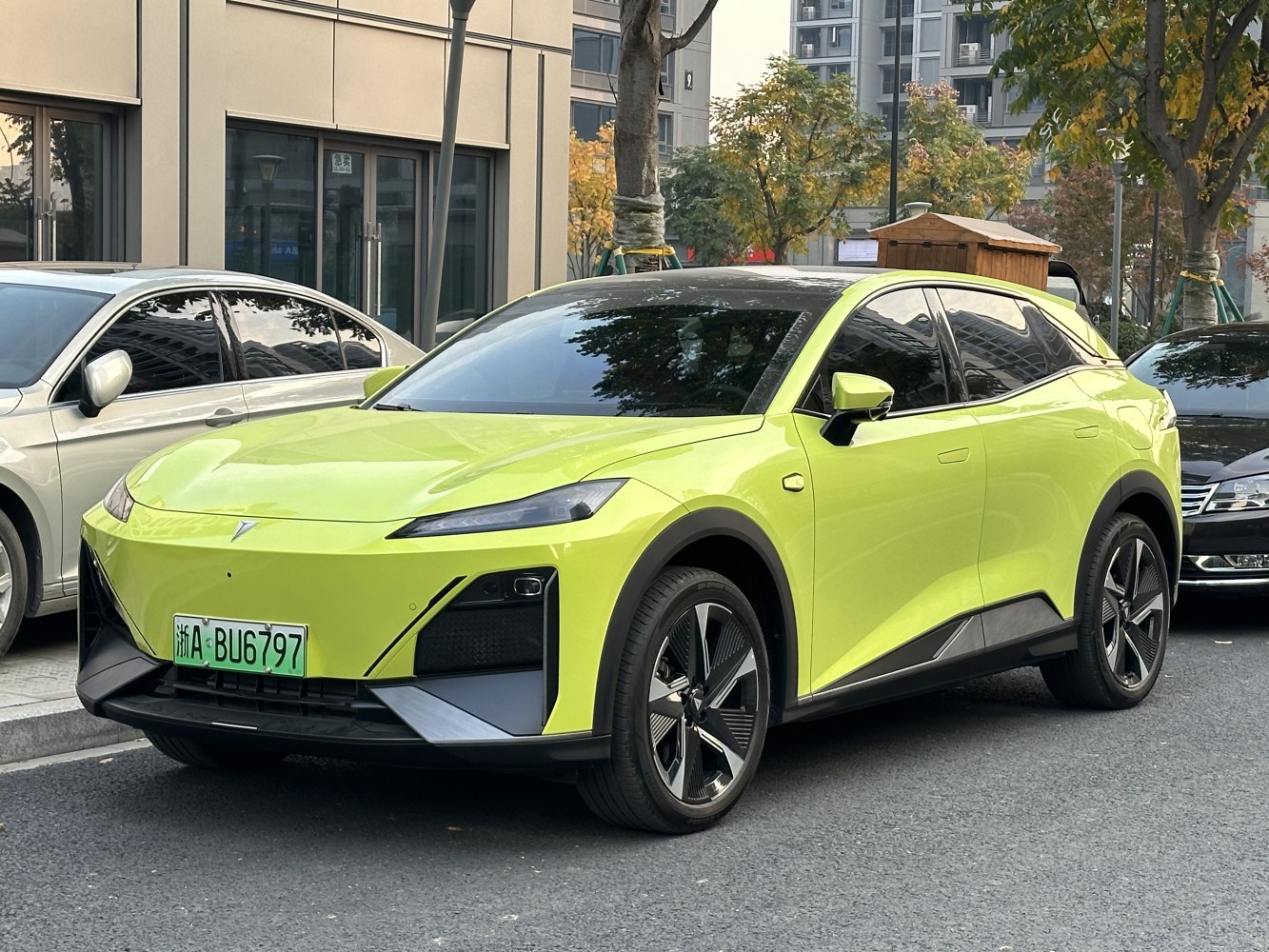 Lime green electric crossover SUV with angular headlights and black roof