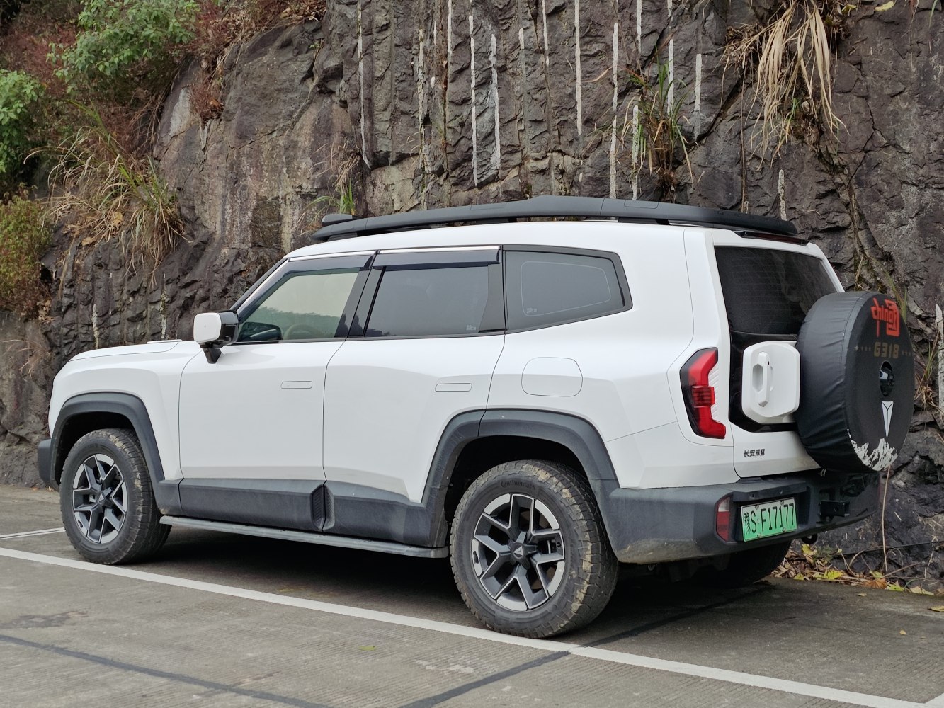 SUV with roof rack and rear spare tire cover