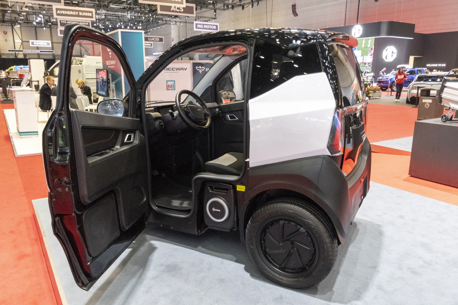 Compact electric nanocar with open door and distinctive wheel design
