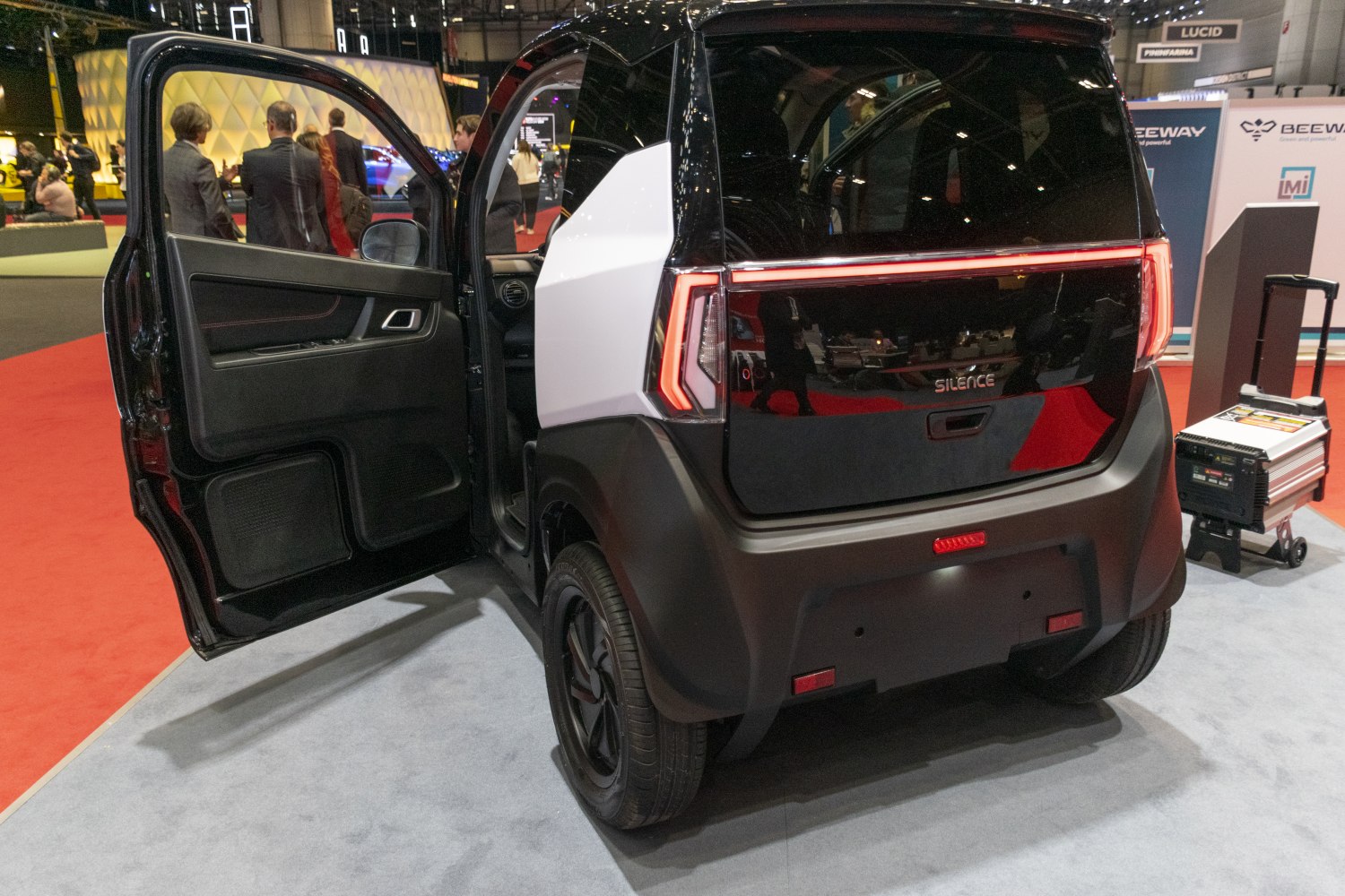 Rear and open door view of electric microcar with modern tail lights