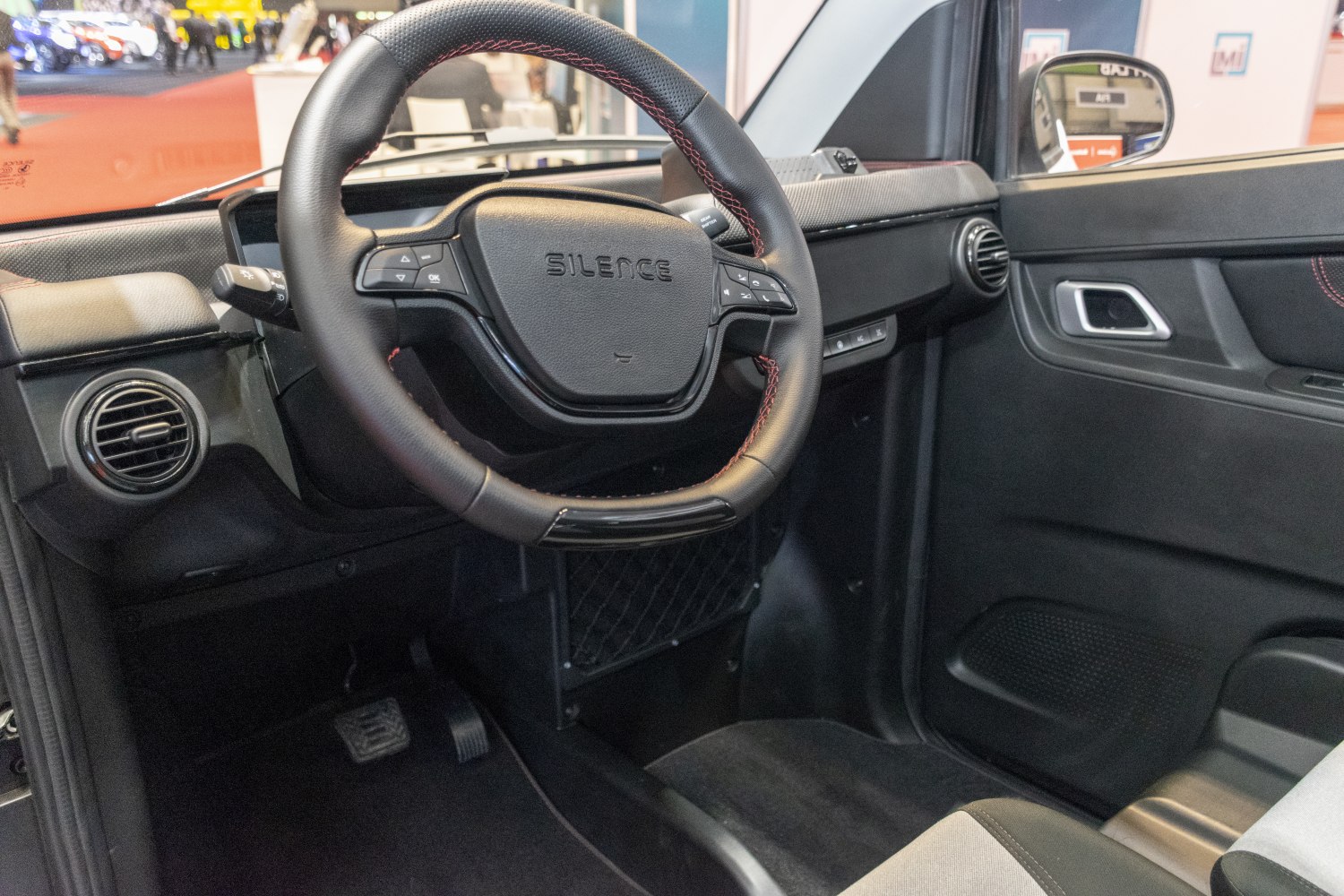 Steering wheel with integrated controls and minimalist dashboard interior