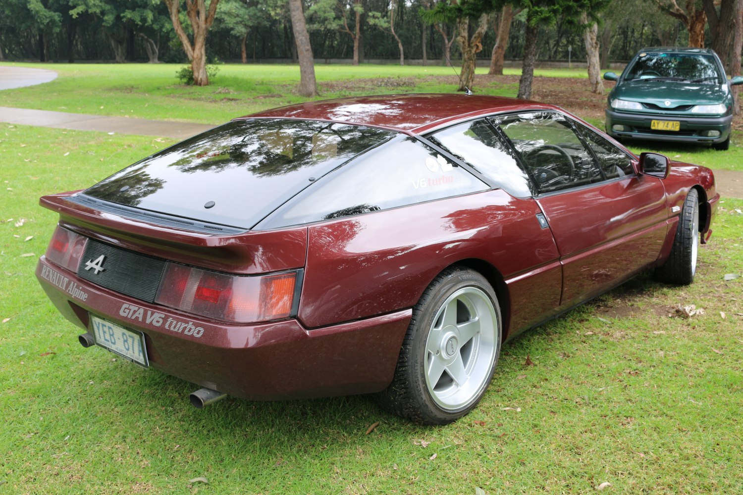 Aerodynamic rear design with spoiler and sleek V6 turbo coupe silhouette
