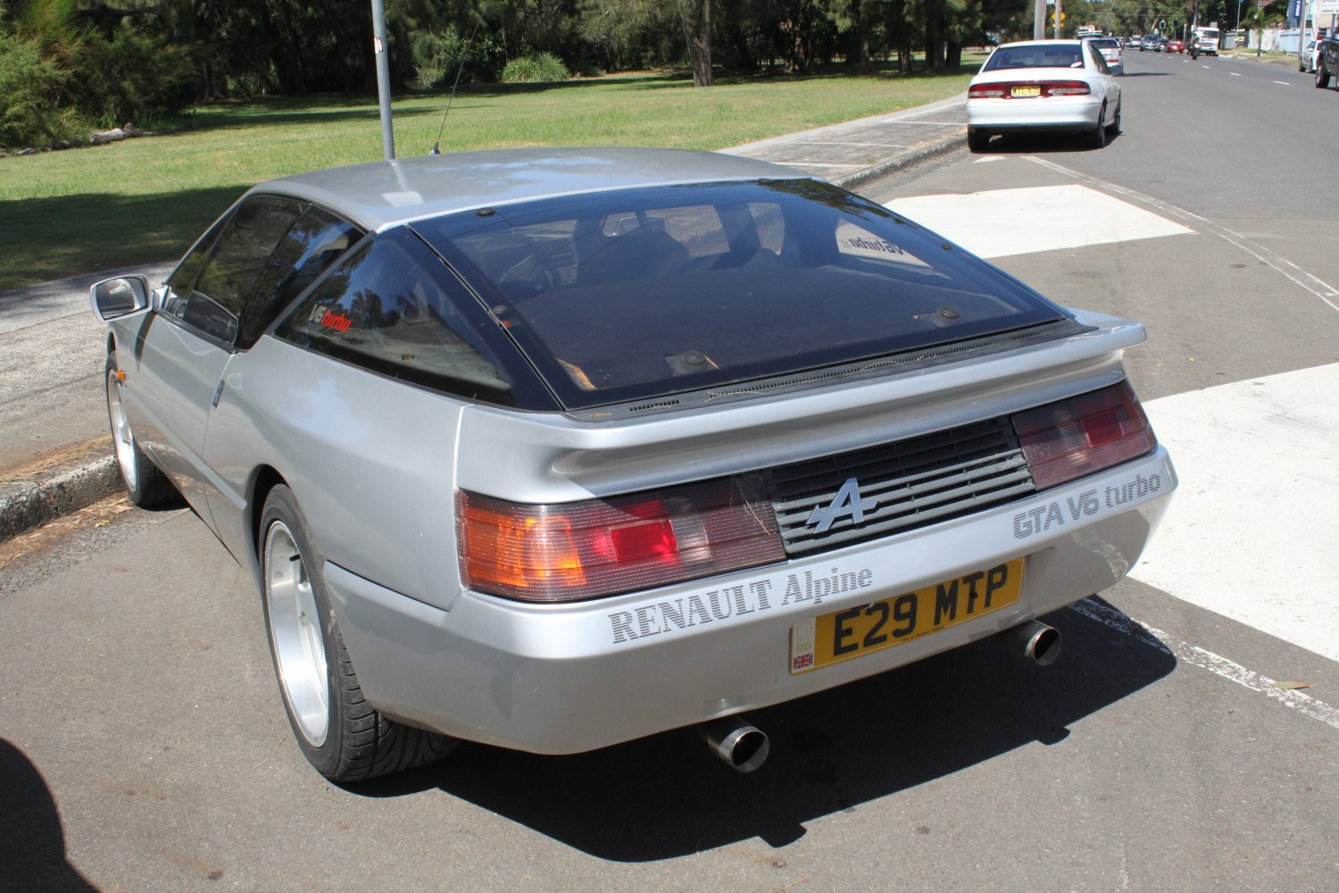 Rear view showing spoiler, taillights, and exhaust pipes