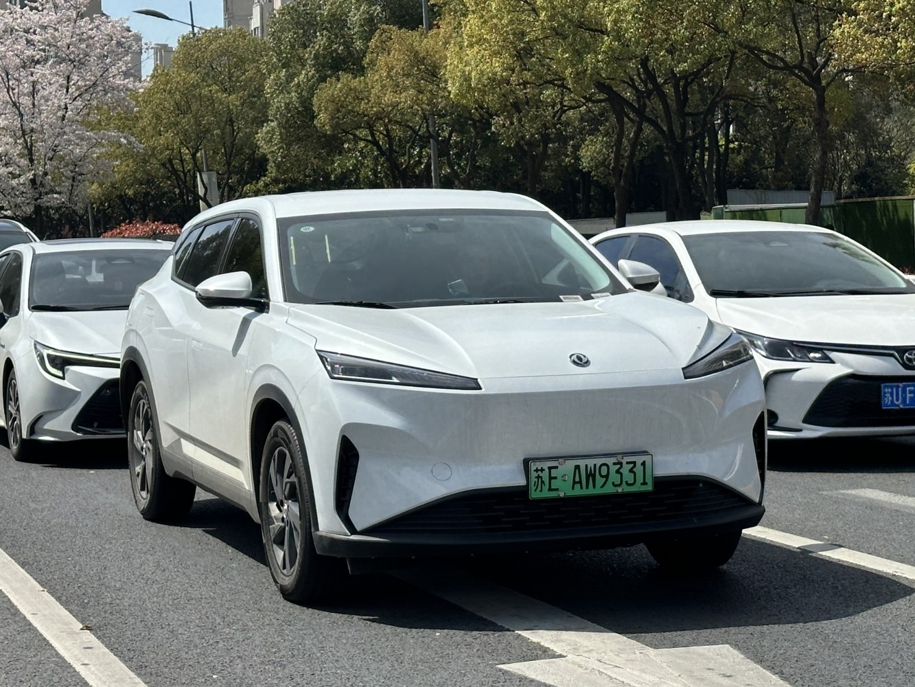 Front view of sleek electric SUV with slim LED headlights
