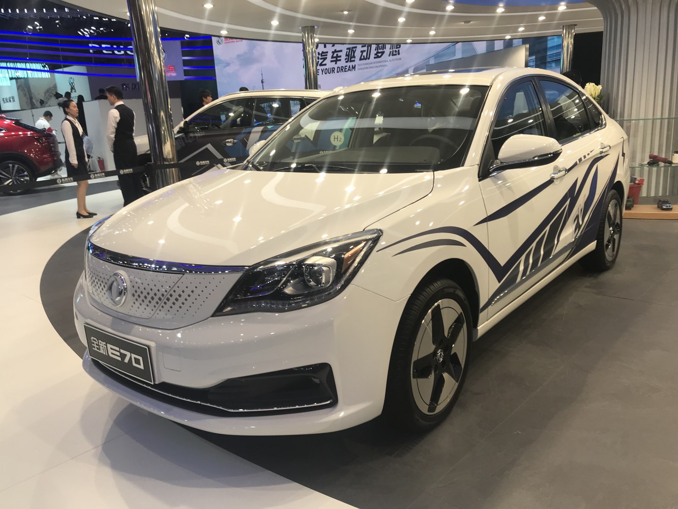 Front grille, LED headlights, side electric-themed decals on sedan