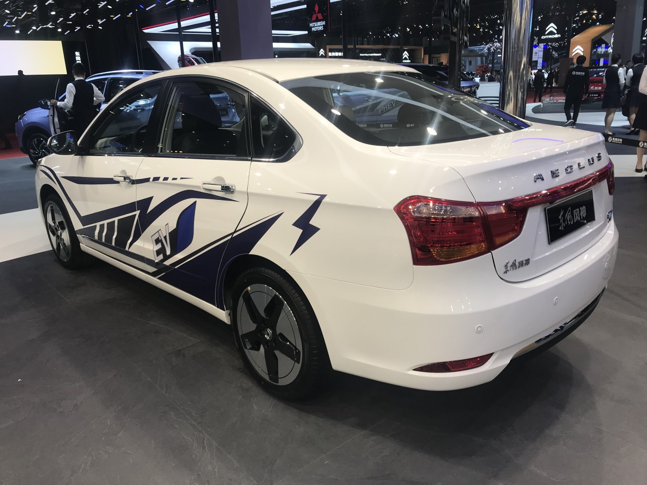 Electric sedan with rear and side views, EV decals, aerodynamic design