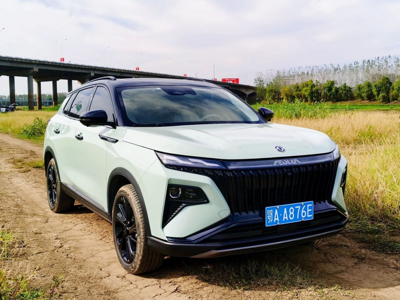 Front view with modern sharp LED headlights and wide black grille