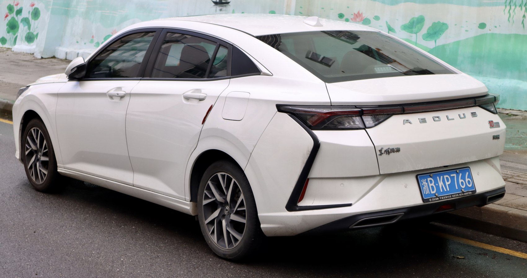 Rear side profile with distinctive tail lights and sleek aerodynamic lines.