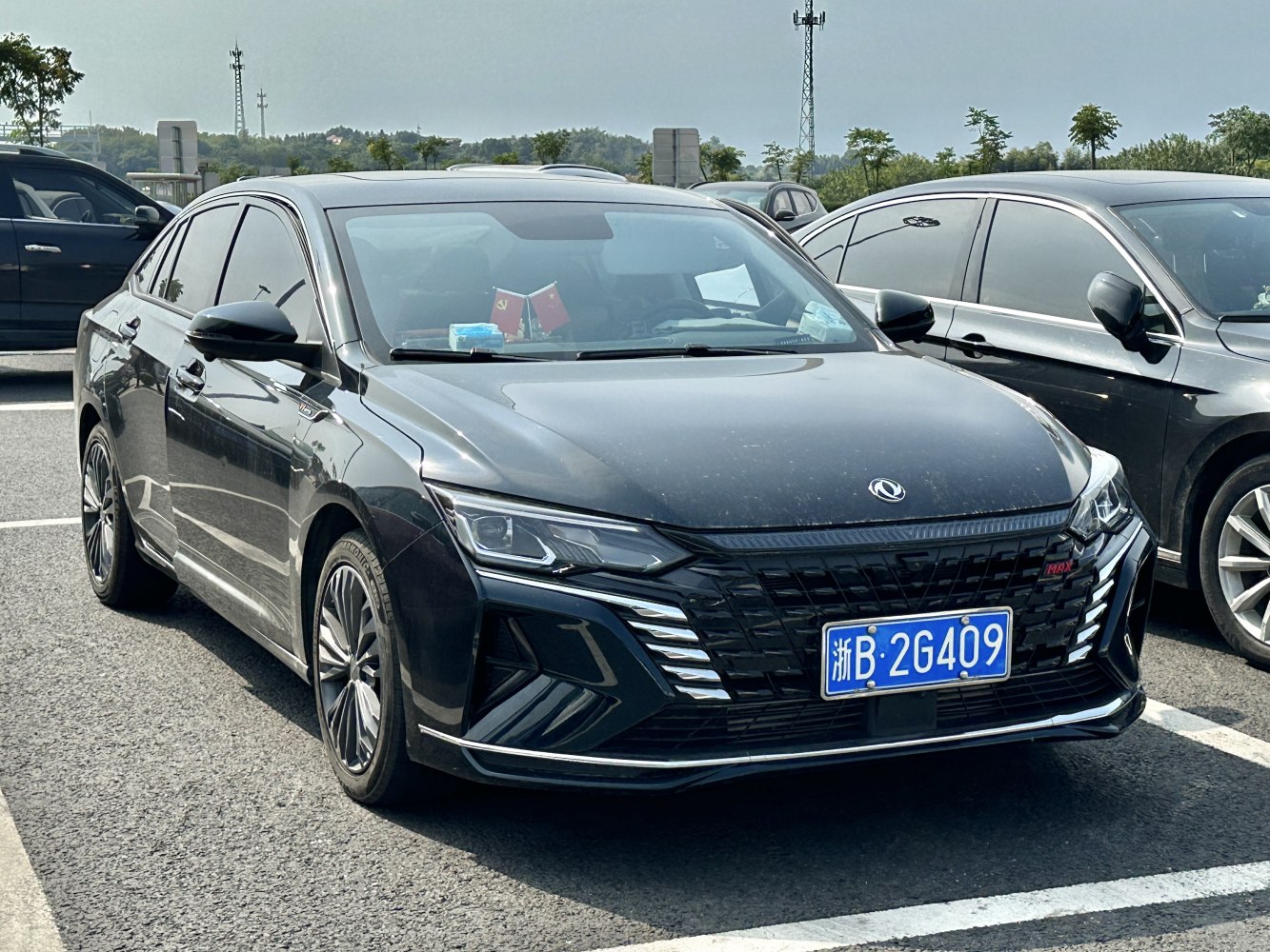 Sleek front grille with LED headlights on a black sedan