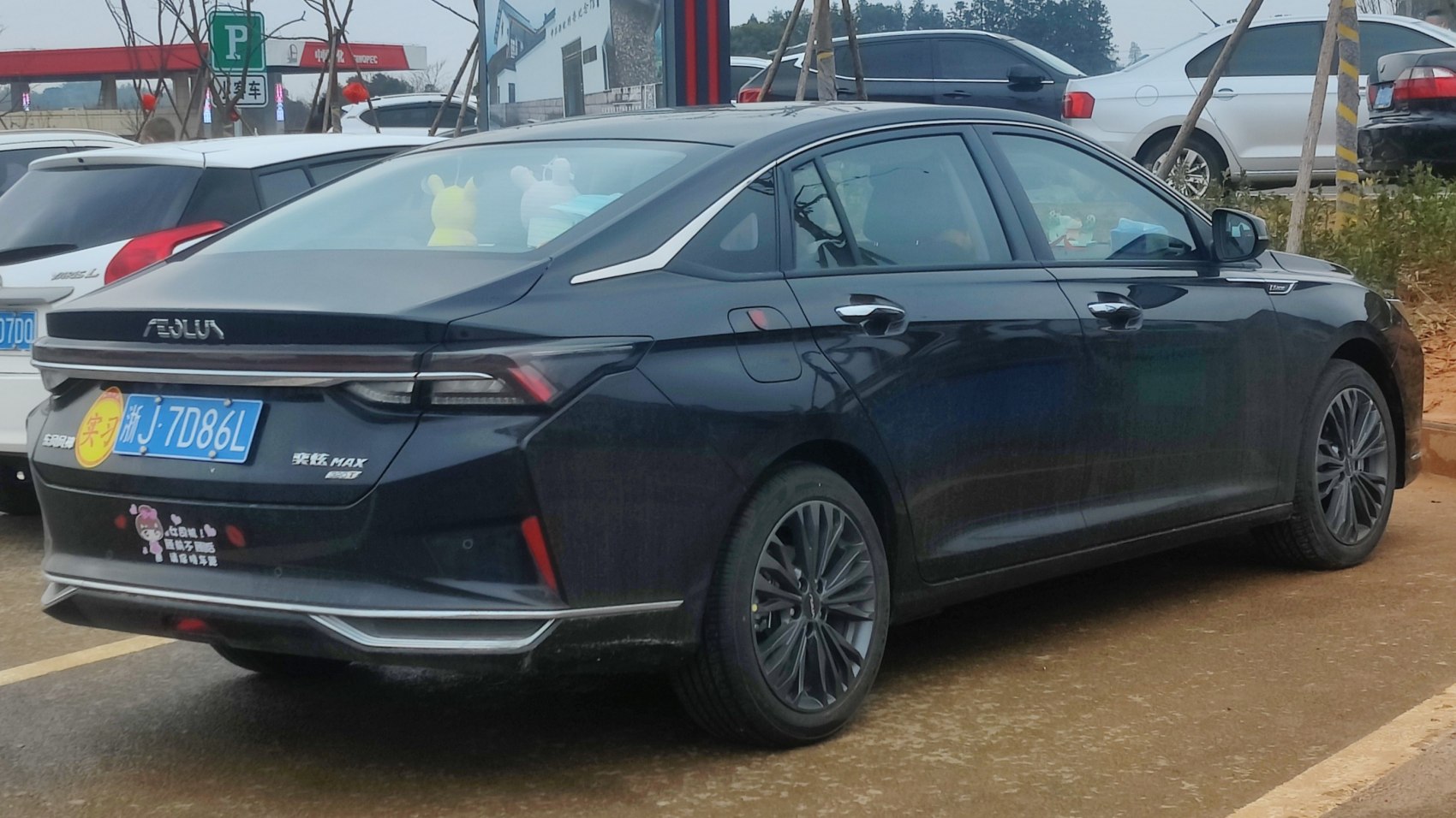 Rear and side view of a sleek sedan with detailed taillights and alloy wheels