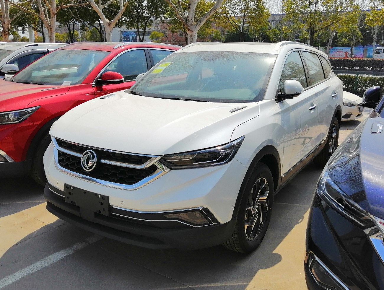 White SUV front view with LED headlights and modern grille