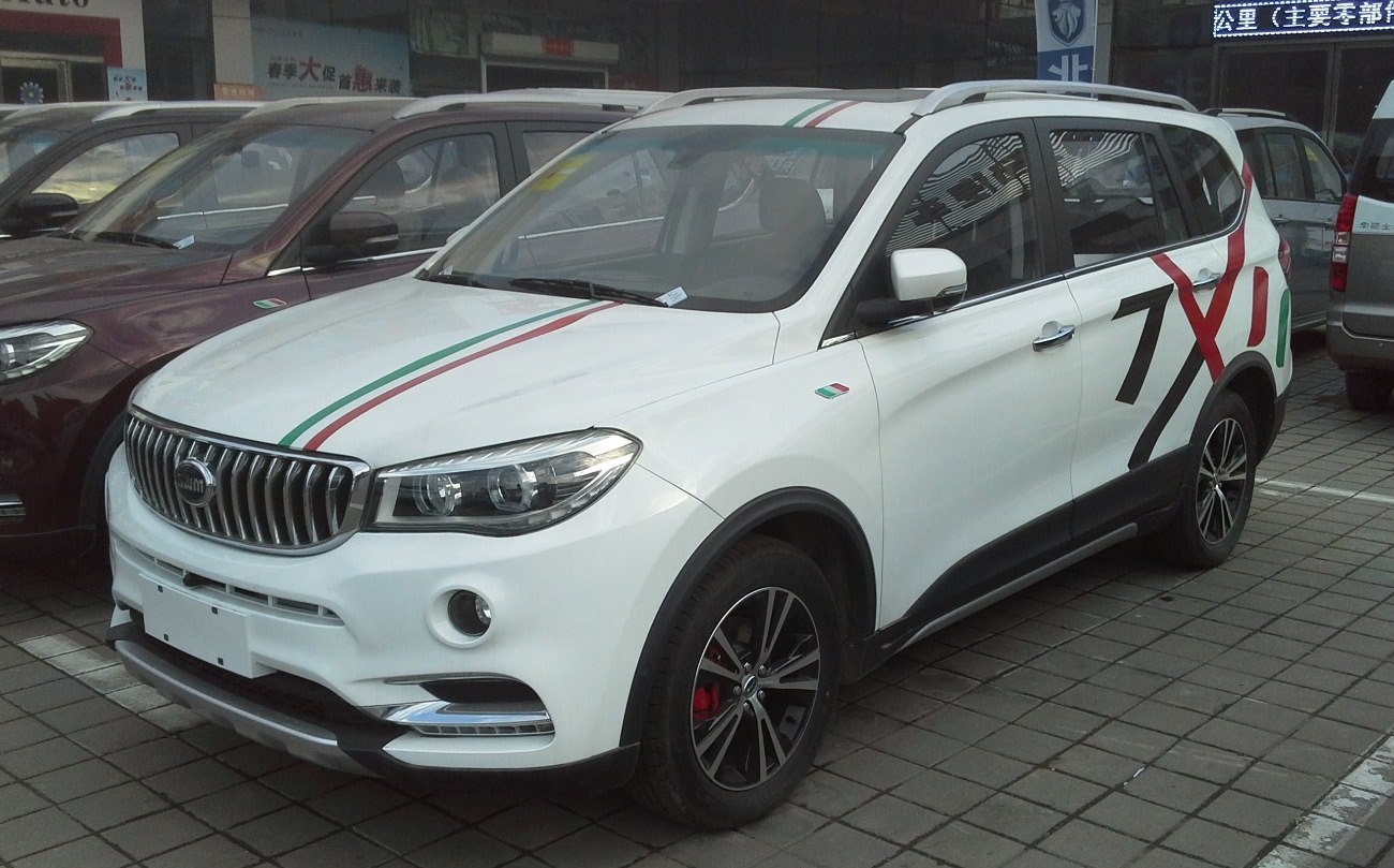 White SUV with Italian flag stripes, sporty wheels, and side graphics.
