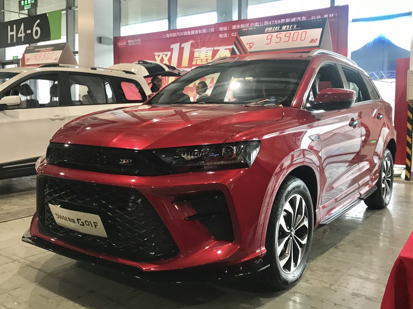 Red SUV with large grille, LED headlights, and alloy wheels