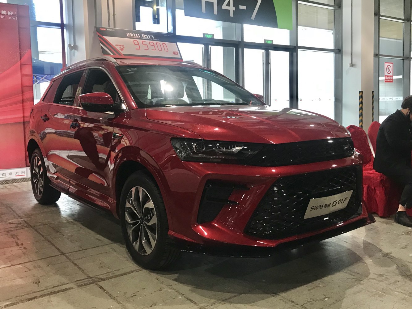 Red SUV with aggressive front grille and alloy wheels