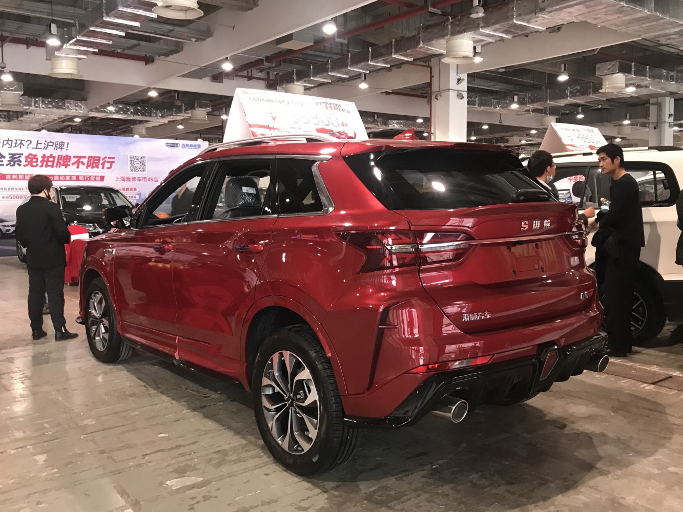 Rear view of a red SUV with LED taillights and dual exhaust pipes