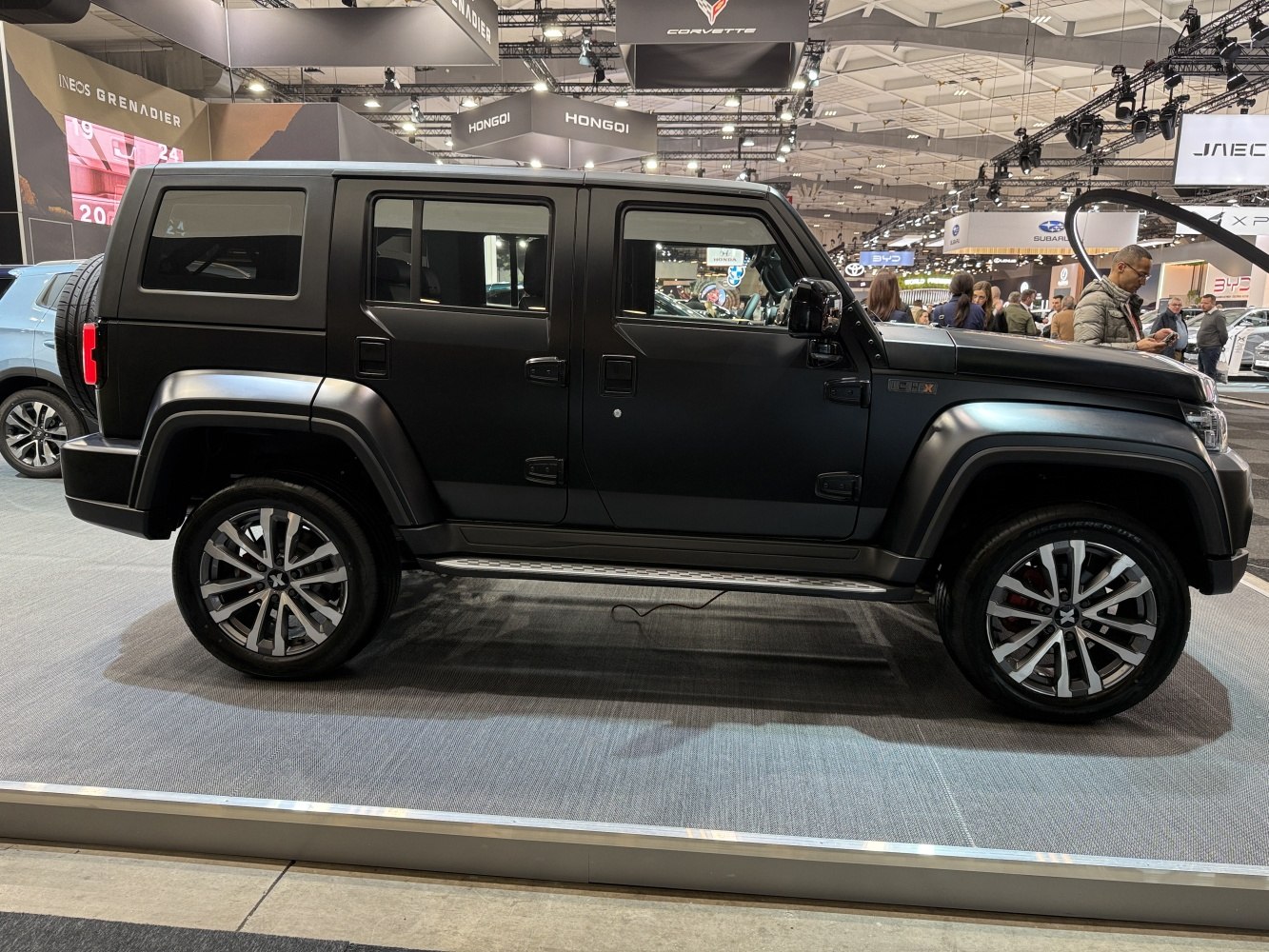 Matte black SUV with four doors and distinctive alloy wheels.