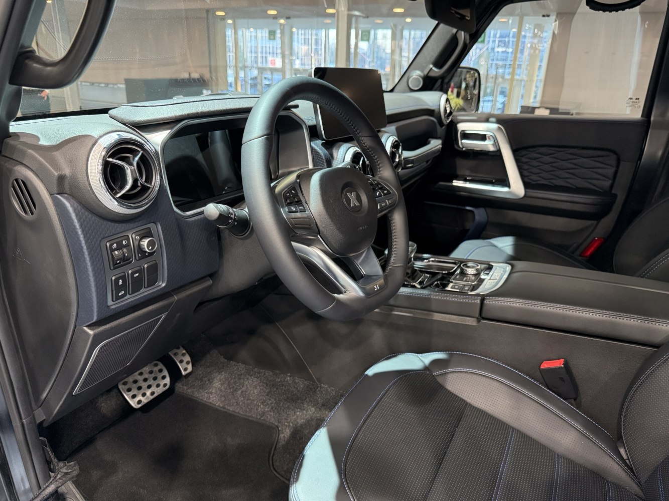 Modern car interior with steering wheel and dashboard controls