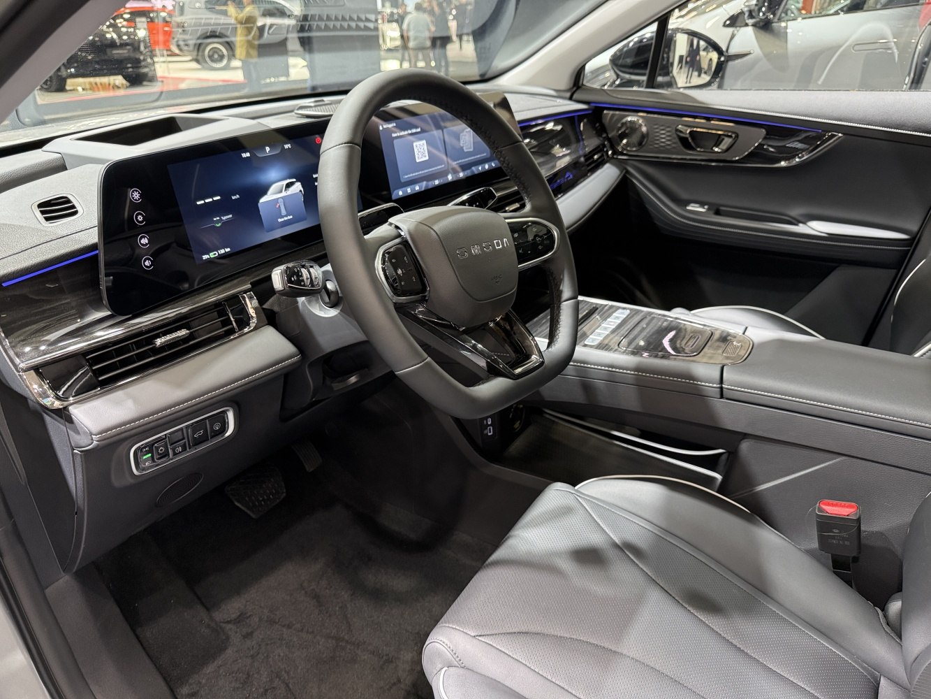 Dual digital displays and modern multifunction steering wheel in car interior