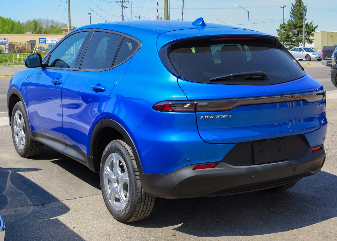 Rear view of a blue SUV with LED taillights and tinted windows.