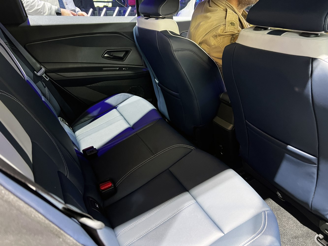 Modern leather rear seats with detailed stitching and door panel