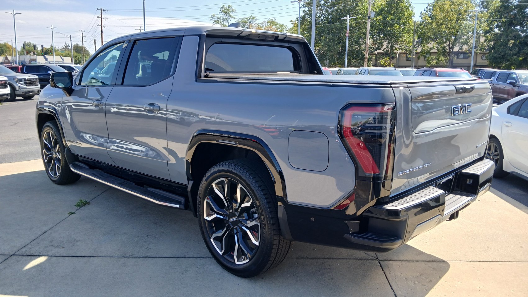 Rear and side view of electric pickup with distinct taillights and wheels