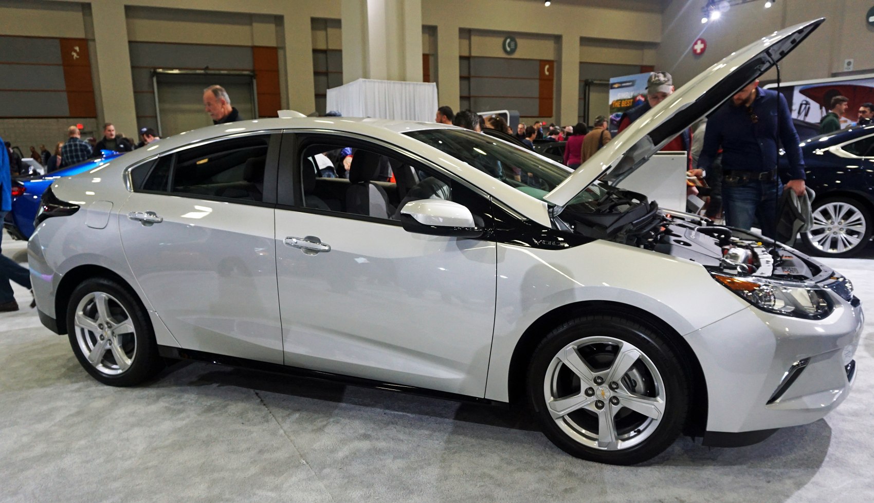 Side profile and open hood view of electric hybrid sedan