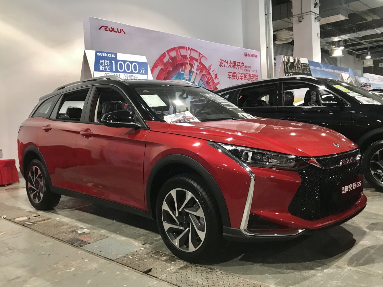 Red SUV with modern grille and sleek headlights from front-side angle