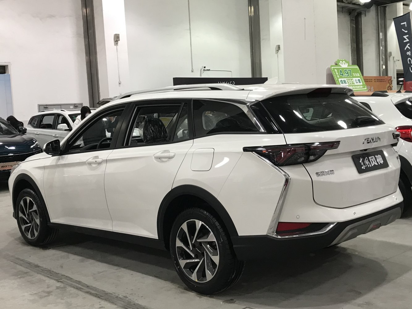 White SUV with black roof rails and angular rear design