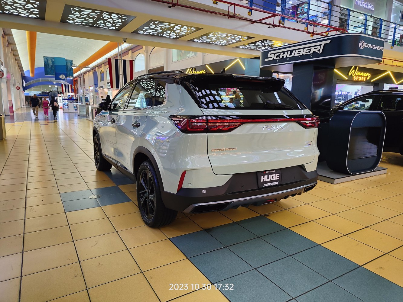 Modern SUV rear view with sleek tail lights and black roof.